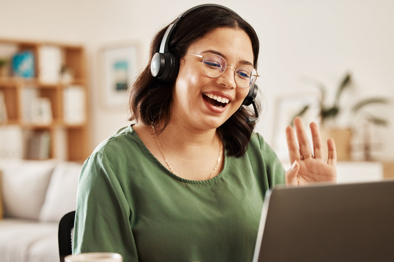 A Guide on a video call with a Seeker, laptop open, smiling.